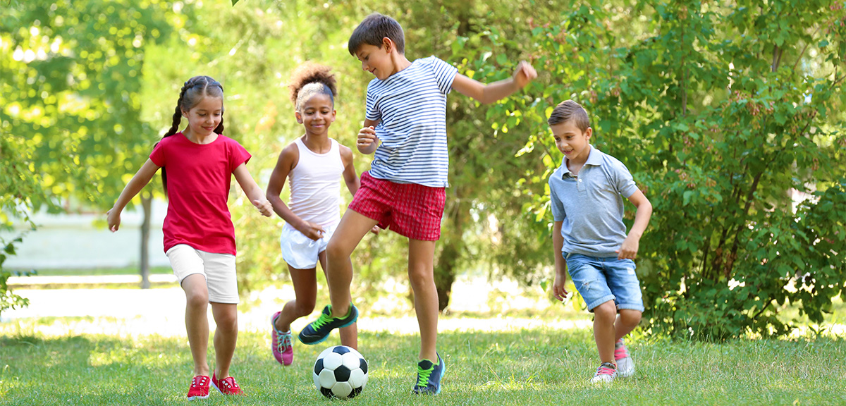 Happy Young Children Playing Soccer Outside 2
